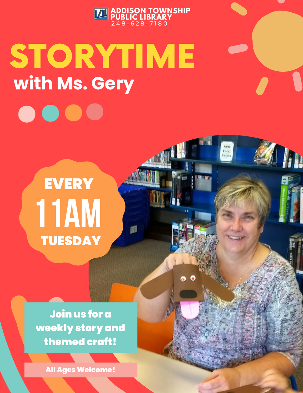 A picture of Ms. Gery holding up a cute craft in the library.